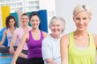 © WavebreakMediaMicro - Women practicing yoga during fitness class