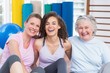 © WavebreakmediaMicro - Happy female friends sitting together in gym