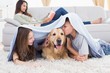 © WavebreakMediaMicro - Siblings with dog under blanket