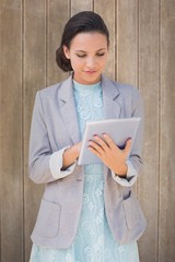 Poster - Composite image of brunette using tablet pc