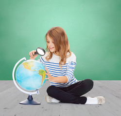 Poster - happy girl looking at globe with magnifier