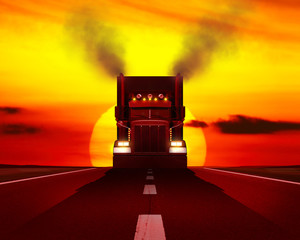 Truck moving on the road against the setting sun.