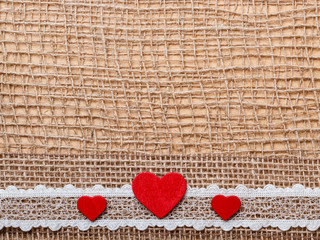 Wall Mural - Red hearts on abstract cloth background