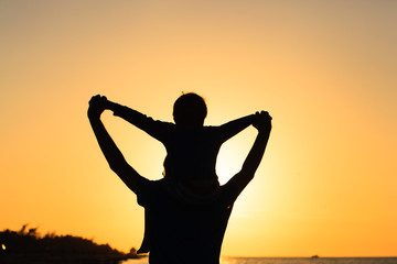 father and son having fun on sunset