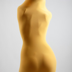 perfect sexy female body in yellow fabric, back view, isolated s