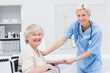 © WavebreakmediaMicro - Friendly nurse holding senior patients hand