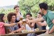© WavebreakMediaMicro - Pretty oktoberfest girl serving friends