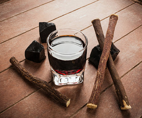 Licorice liqueur with pure blocks and roots.