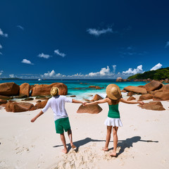 Couple in green having fun on a beach at Seychelles