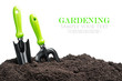 garden tools in soil isolated on white