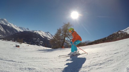 Fototapete - Skiing - young girl skiing down