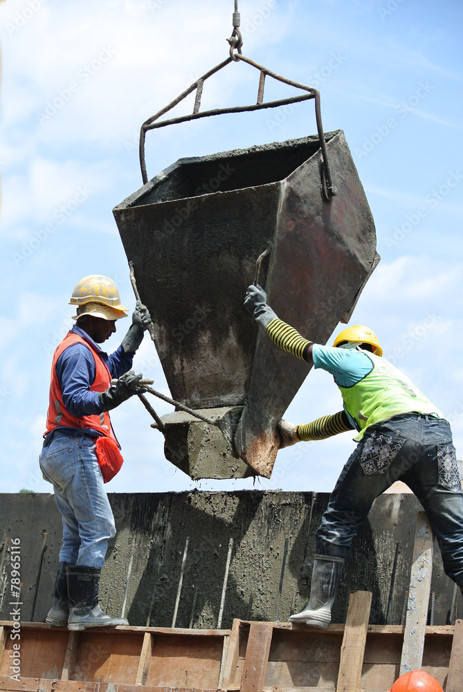 Group of construction workers casting concrete retaining wall Stock ...