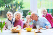 © cromary - Grandparents with grandchildren enjoying Easter breakfast