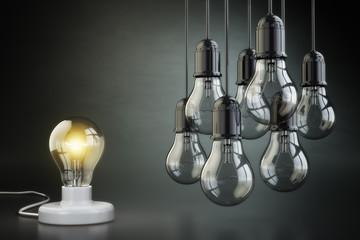 Poster - Idea or leadership concept. Group of lightbulbs on the black bac