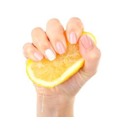 Wall Mural - Female hand squeezing lemon isolated on white