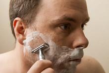 Man Shaving His Cheek