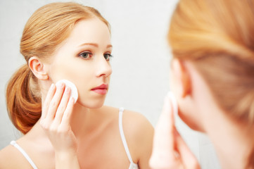 Wall Mural - beautiful young woman removes makeup with face skin