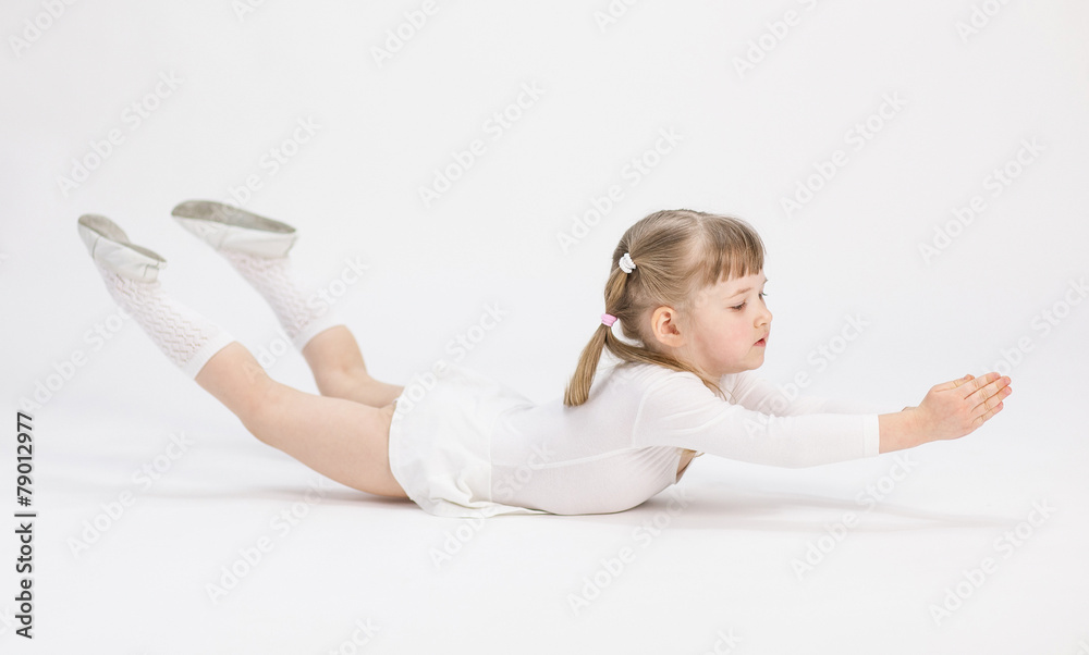 Pretty little girl lying on the floor and doing exercise Stock Photo ...