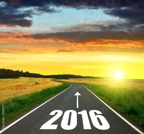 Fotografie, Obraz Asphalted road at sunset .Forward to the New Year 2016