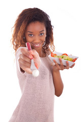 Wall Mural - African American woman eating salad, isolated on white backgroun