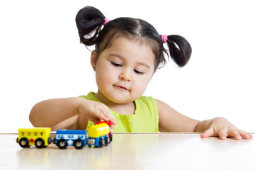 Fototapete - Cute kid girl playing trains