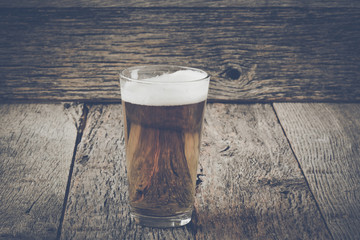 Pint of Pilsner Beer on Wood Background with Vintage Instagram F