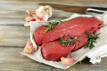 Raw beef steak with rosemary and garlic