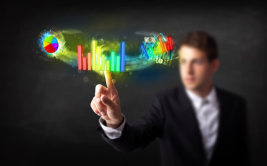 Poster - Handsome young business man touching colorful modern graph syste