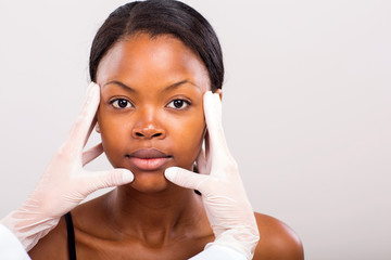 doctor doing skin check on african woman