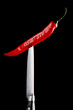 © blackday - Red chili pepper and knife