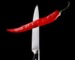 © blackday - Red chili pepper and knife