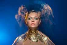 Close-up Portrait Girl Model In A Stylish Gold Foil. Blurred Mar
