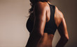 © Jacob Lund - Back of a fit woman athlete in sports bra