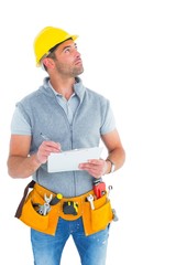 Poster - Manual worker looking away while writing on clipboard
