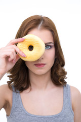 Poster - Serious young woman looking at the camera through donut