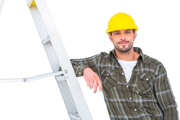 Poster - Smiling handyman in overalls leaning on ladder