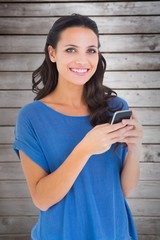 Poster - Composite image of pretty brunette sending a text