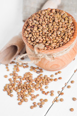 Wall Mural - Dry Organic Brown Lentils against a wooden background