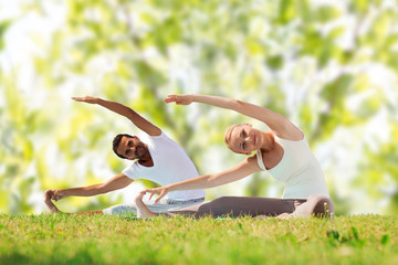 Canvas Print - happy couple stretching and doing yoga exercises