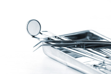 Canvas Print - Dentist tools in metal tray isolated on white