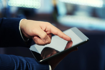 Male hand touching screen tablet close-up