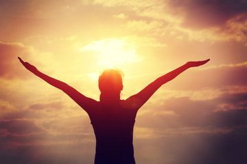 cheering woman open arms at sunrise seaside