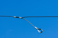 Single Thin Metal Cable Loop Hanging On Sky