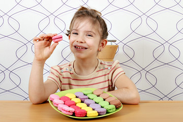 Wall Mural - beautiful little girl eat macaroons