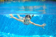 © Iuliia Sokolovska - Happy girl swims in pool underwater, active kid swimming