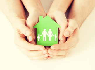 Wall Mural - hands holding green house with family