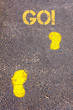 Yellow footsteps on sidewalk towards Go message