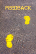 Yellow footsteps on sidewalk towards Feedback message