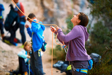 Belayer With The Rope And Carabines