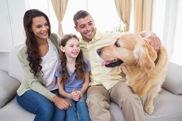 Sticker - Family looking at Golden Retriever on sofa